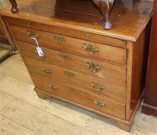 A George III fruitwood chest of drawers with brushing slide W.89cm